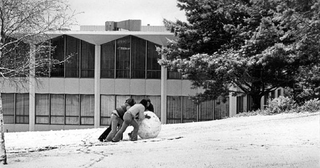 Students rolling a snowball toward Building 14