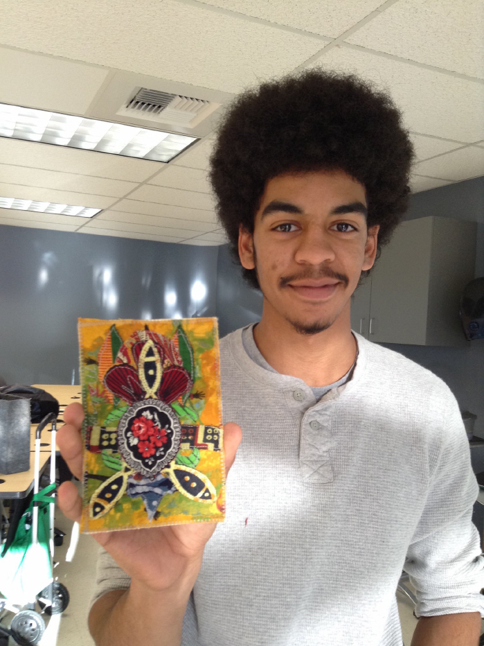 A student displays his handiwork from 2016’s Stitch Africa quilt workshop