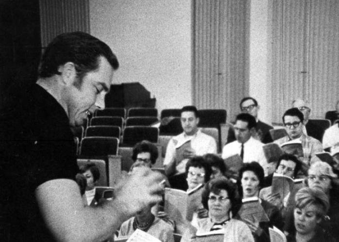 Galen Marshall conducts chorale practice on campus in the 1960s