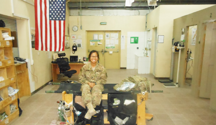 Wong, an Army medic in Afghanistan, between patients in her base aid station