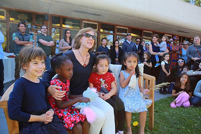 Former CSM Child Development Center Coordinator Louise Piper surrounded by children