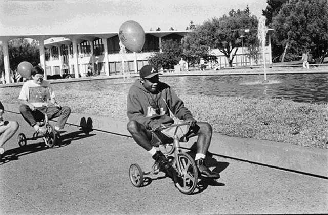 Students race tricycles during a 1970s or 1980s Spring Fever week